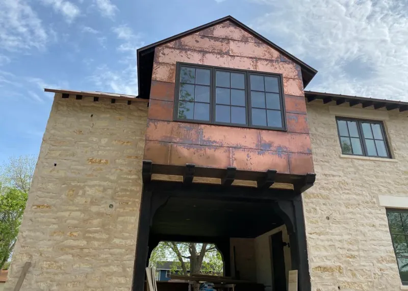 Copper metal panel facade on a stone building for Metal Roof Coating in Brambleton